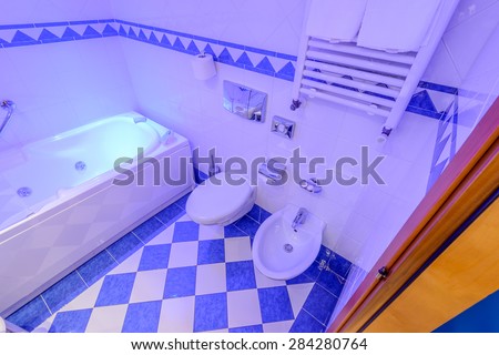 Fragment of a luxury bathroom in blue light.