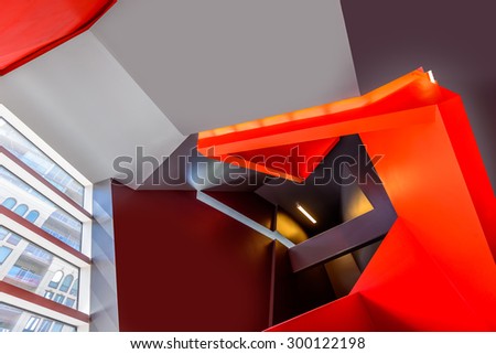 Painted in red. Abstract fragment of the architecture of modern lobby, hallway of the luxury hotel, shopping mall, business center in Vancouver, Canada. Interior design.