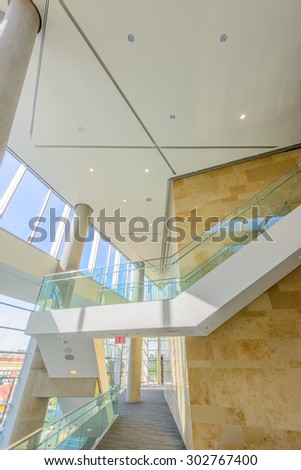 Window and blue sky. Abstract fragment of the architecture of modern lobby, hallway of the luxury hotel, shopping mall, business center in Vancouver, Canada. Interior design.