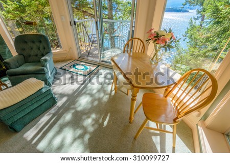 Table with flowers and two chairs. Interior design of a luxury living room.