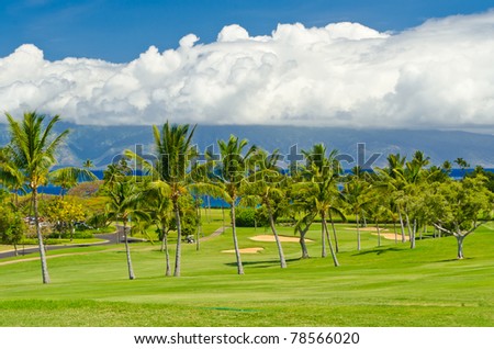 Beautiful golf place with gorgeous green and fantastic white clouds over blue sky
