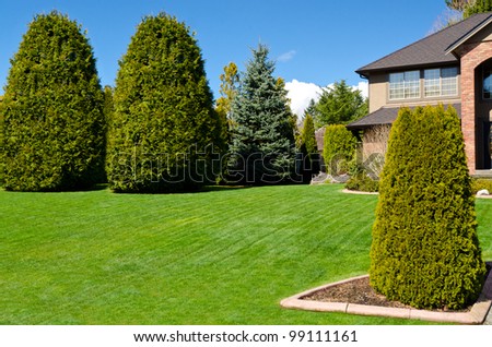 Fragment of a nice house with gorgeous lawn and outdoor landscape in Vancouver, Canada.