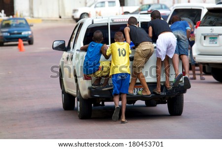 PANAMA CITY, PANAMA - JANUARY 18, 2014: Unidentified children riding on back of truck in streets of Casco Viejo the historic district of Panama City which was designated a World Heritage Site in 1997