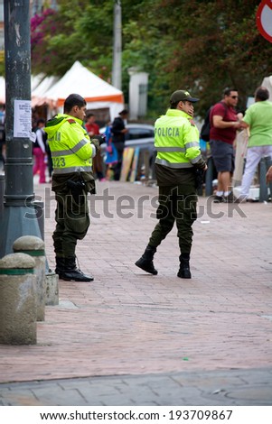 BOGOTA, COLOMBIA - MAY 04, 2014: Two Colombian National Police officers working their post in Bogota Colombia. The Colombian National Police is the largest police force in Colombia.