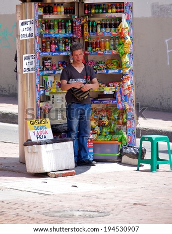 BOGOTA, COLOMBIA - MAY 06, 2014: Vendor selling food drinks and snacks along a busy street in Bogota. Street vendors are very common in the streets of Bogota.