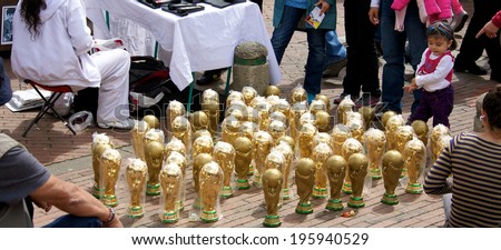 BOGOTA, COLOMBIA - APRIL 06, 2014: Replica World Cup trophies being sold at an open air market in Bogota Colombia. The World Cup is played in Brazil in June 2014.
