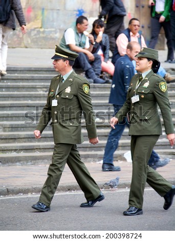 BOGOTA, COLOMBIA - MAY 06, 2014: Two Colombian National Police officers working their post in Bogota Colombia. The Colombian National Police is the largest police force in Colombia.