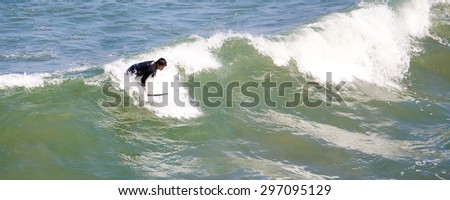 IMPERIAL BEACH, CALIFORNIA - June 3, 2015: People surfing at Imperial Beach California. Imperial Beach is the southernmost beach city in Southern California and the West Coast of the United States