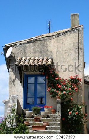 A rustic country house in a French village with a blue door