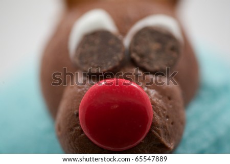Close up of a reindeer made of chocolate with a red nose