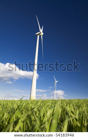 Windmills against a blue sky and clouds, alternative energy source