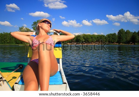 blonde girl rides on catamaran
