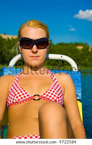 blonde girl rides on catamaran