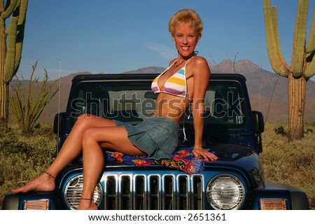 Woman with Jeep in Desert