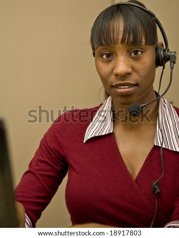 An attractive African American customer support  representative, office worker or business woman.