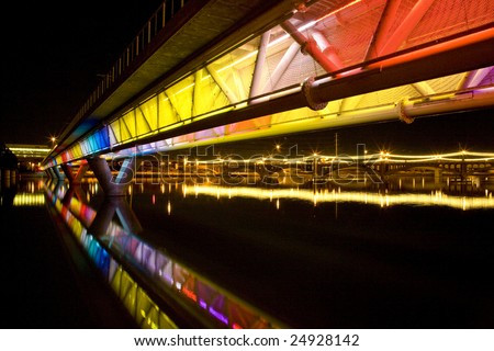 Colorful light rail bridge across the Salt  River in Tempe Arizona photographed at night.