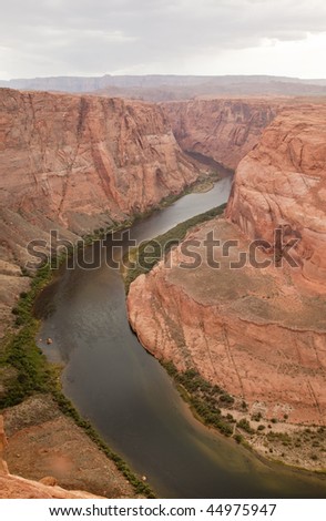 Horseshoe Bend, an entrenched meander on the  Colorado River near Page Arizona with a storm  in the background.