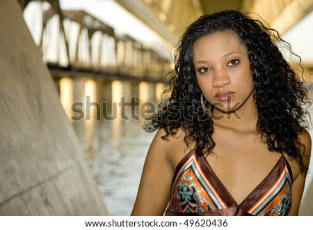 African-american Fashion model shot in an urban setting on a  waterfront.