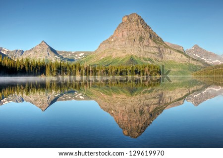 A morning reflection on Two Medicine Lake in Glacier National Park, Montana.
