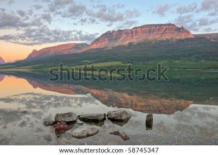 A reflection of the East Flattop Mountain and Napi Point on Saint Mary Lake in Glacier National Park, Montana.