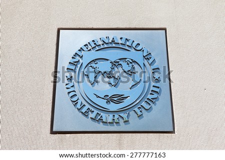 WASHINGTON, DC - MAY 4: Plaque outside the International Monetary Fund (IMF) reflects the blue sky in Washington, DC on May 4, 2015. The IMF, created in 1945, is an organization of 188 countries.