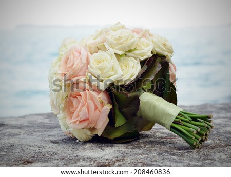 bridal bouquet of light roses on the water background