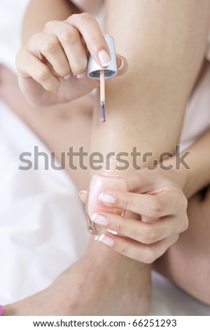 Dipping the nail polish brush in the vial