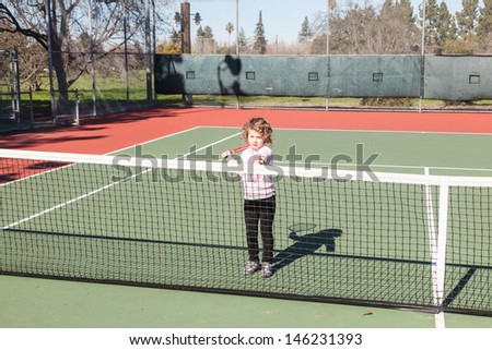 Having fun on a tennis court on sunny day.
