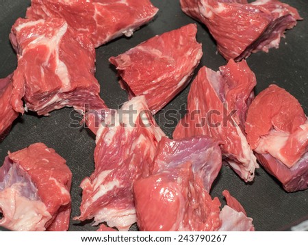 Pieces of raw beef in a pot ready to cook a broth
