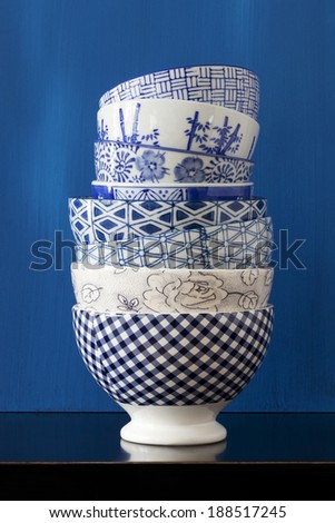 Stack of porcelain bowls with blue and white designs