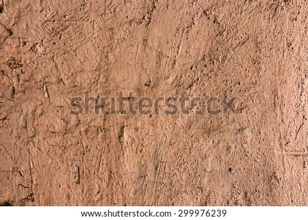 Stone wall background with cracked paint and holes