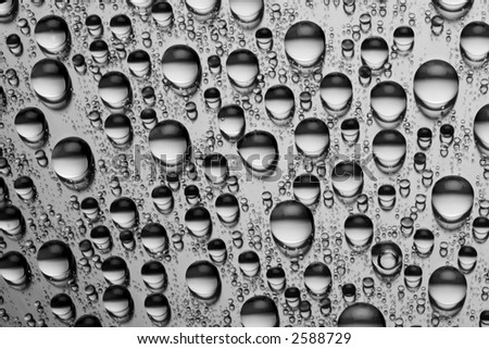 Black and white photo of water drops on a metallic surface