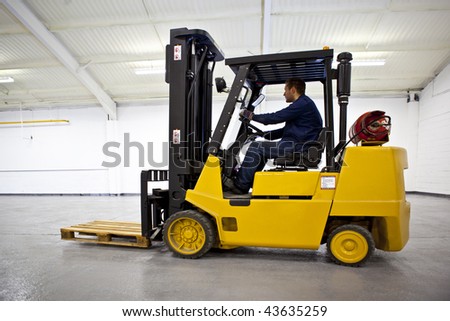 Forklift Truck in empty Warehouse with driver
