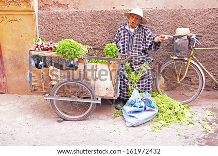 MARRAKECH, MOROCCO - OCTOBER 22:Maroccan man selling vegetables at the market at Marrakech, Morocco on 22th october 2013