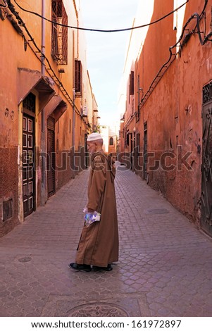 FES, MOROCCO - OCTOBER 22, old man in the medina in Fes on Eid al-Adha. The festival is celebrated by sacrificing a lamb or other animal and distributing the meat to relatives, friends, and the poor.