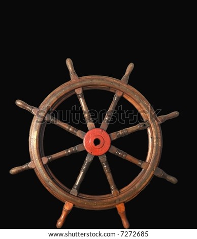 Steering wheel from wood from an old ship isolated on black