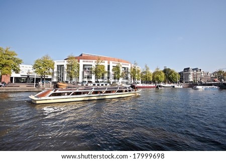 Cruising on the river Amstel with the Stopera in Amsterdam Netherlands