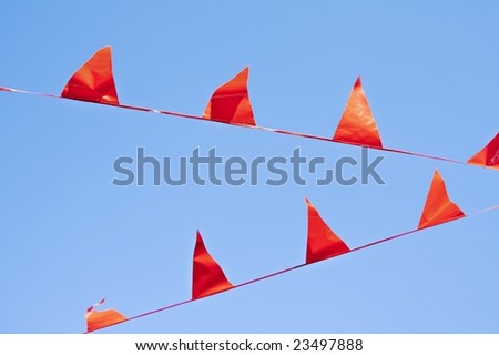 Little orange flags against a blue sky
