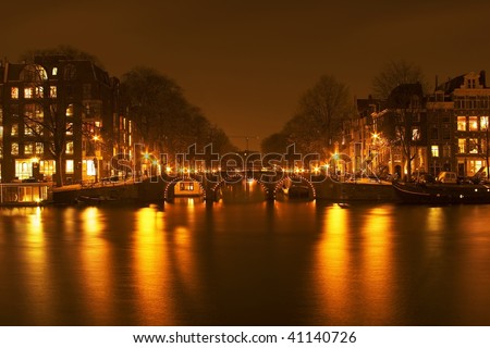 Amsterdam by night with the river Amstel in the Netherlands