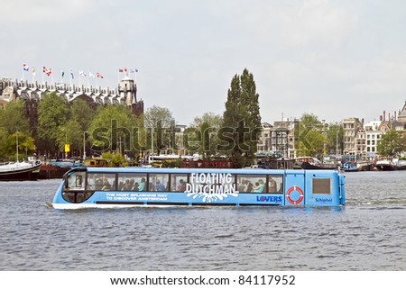 AMSTERDAM - JULY 16: New way to attract tourism to Amsterdam: Floating bus is cruising through Amsterdam canals, july 16, 2011 in Amsterdam the Netherlands