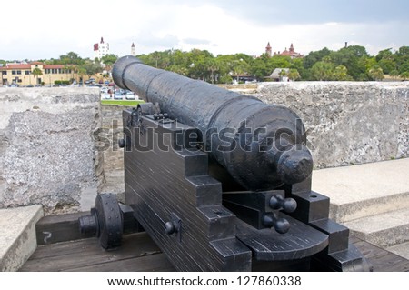 Old canon aiming at the sea, on an overcast day. Old Castillo de San Marcos, St. Augustine, Florida