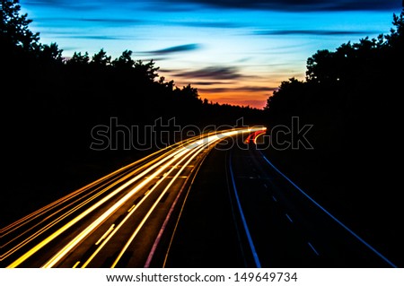 An image of Car lights on a highway at night
