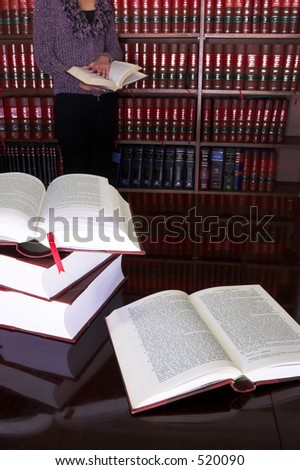 Legal books on table - South African Law Reports, Intern doing research