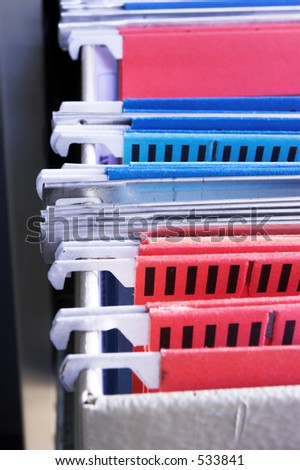 Heap of coloured files in sliding filing cabinet