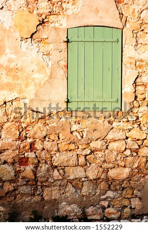 An old locked window in the famous Ile Sainte Marguerite â€“ Island Jail, across from Cannes, France