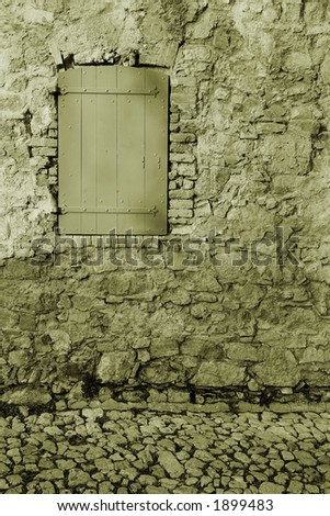An old locked window in the famous Ile Sainte Marguerite â€“ Island Jail, across from Cannes, France - Sepia Tone