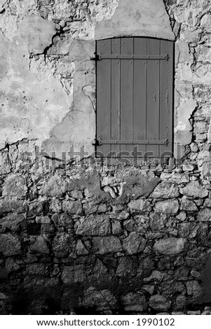 An old locked window in the famous Ile Sainte Marguerite â€“ Island Jail, across from Cannes, France - Black and White