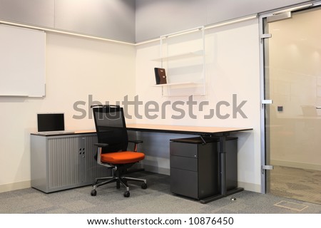 Empty office with new modern office furniture, including desks, cupboards, filing cabinets and chairs. Two blue chairs facing out. HDR type image