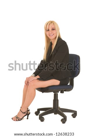 Sexy young adult Caucasian businesswoman in black pinstripe pencil skirt and suit jacket on a white background, sitting on an office chair