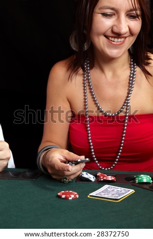 People playing cards, chips and players gambling around a green felt poker table. Shallow Depth of field. Focus on the Hand and Chips